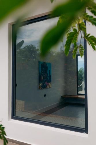 a mirror on a wall with a picture in it at Safira Blu Luxury Resort & Villas in Nungwi