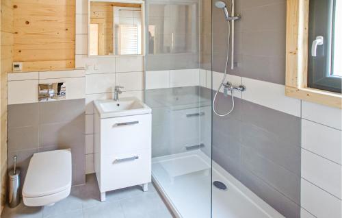 a bathroom with a shower and a toilet and a sink at Gorgeous Home In Mrzezyno With Wifi in Mrzeżyno