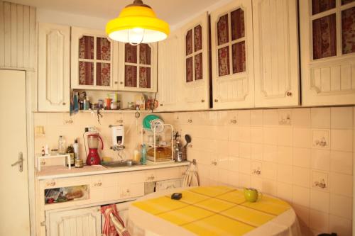 a kitchen with white cabinets and a yellow counter top at Elie's Home in Varna City