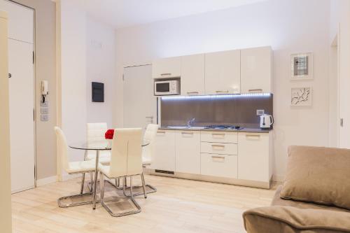 a kitchen with a table and chairs in a room at San Nicolò 3 in Verona