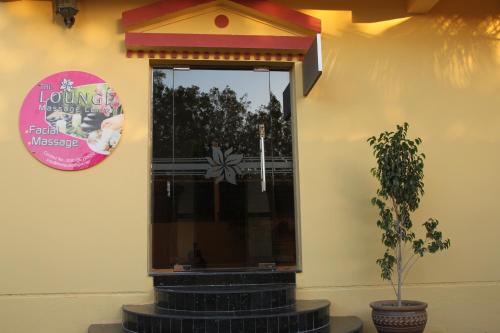 a building with a window and a potted plant at Al Maha Residence Rak in Ras al Khaimah