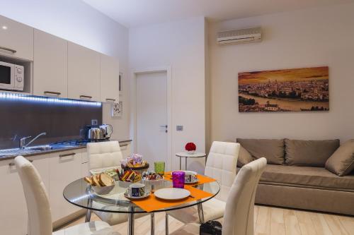 a kitchen and living room with a table and a couch at San Nicolò 3 in Verona