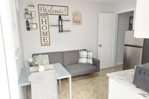 a living room with a couch and a table at The Torres' Loft West Tampa MidTown Raymond James Stadium in Tampa