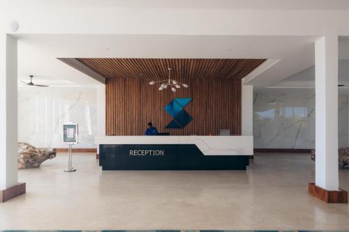a lobby with a reception desk in a building at Safira Blu Luxury Resort & Villas in Nungwi