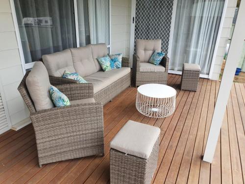 a porch with two chairs and a couch and a table at Matildas of Kangaroo Island in Baudin Beach