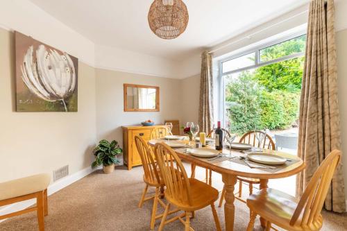 a dining room with a table and chairs and a window at St Clements House - Norfolk Holiday Properties in Norwich