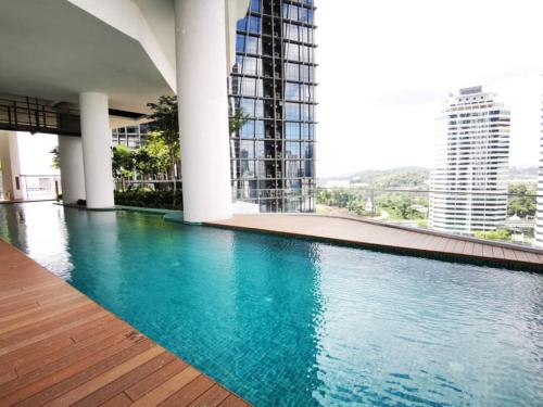 a large swimming pool in a building with tall buildings at PROMO Connected train 4 Bedroom ABOVE MALL 20 in Kuala Lumpur
