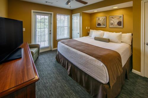 a hotel room with a bed and a flat screen tv at Holiday Inn Club Vacations Hill Country Resort at Canyon Lake in Canyon Lake