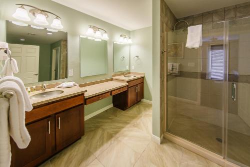 a bathroom with a shower and a sink and a mirror at Holiday Inn Club Vacations Hill Country Resort at Canyon Lake in Canyon Lake
