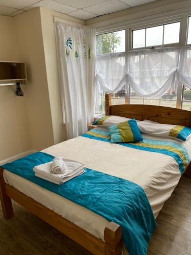 a bedroom with two beds and a window at Clarendon Lodge - accommodation only in Skegness