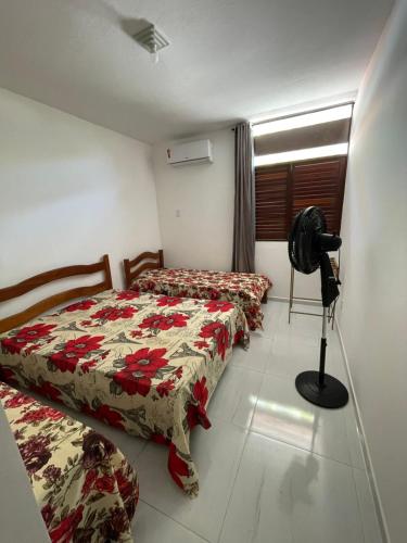 ein Schlafzimmer mit 2 Betten und einer Kamera auf einem Stativ in der Unterkunft Casa na Barra de São Miguel in Barra de São Miguel