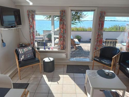 a living room with a view of the ocean at Strand Huset in Fåborg