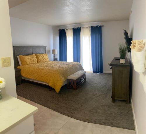 a bedroom with a bed and a window with blue curtains at River Place Condos #711 3BD in Pigeon Forge