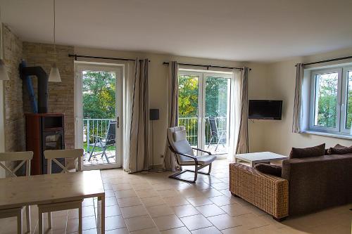 a living room with a couch and a table at Villa-Meehr in Bantikow