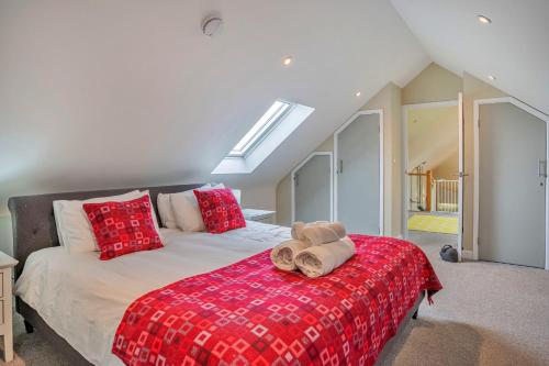 a bedroom with a bed with a red blanket at Finest Retreats - Min Yr Awel Barn in Fishguard