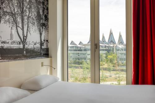 Un pat sau paturi într-o cameră la B&B HOTEL Antwerpen Zuid