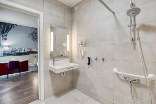a bathroom with a sink and a shower at B&B HOTEL Antwerpen Zuid in Antwerp