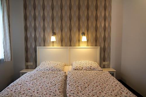 a bedroom with a bed with two pillows at Villa-Meehr in Bantikow