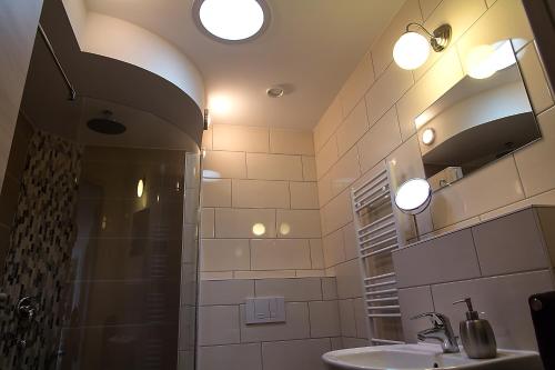 a bathroom with a shower and a sink and a mirror at Villa-Meehr in Bantikow