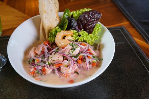 a bowl of soup with shrimp and vegetables on a table at Hotel Parada Linares in Linares