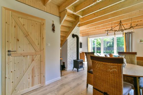 a barn door in a kitchen and dining room with a table at Domki z Pasją in Kopalino