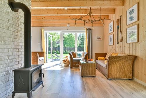 a living room with a wood stove at Domki z Pasją in Kopalino