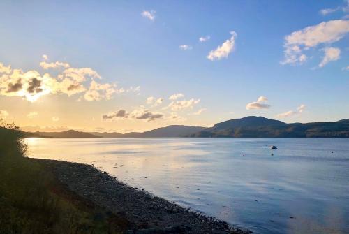 a large body of water with mountains in the background at Chapelton Cottage in Strachur