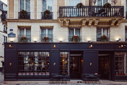 a black building with chairs in front of it at Hotel Panache in Paris