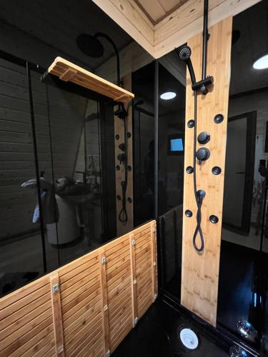 a shower in a room with a wall of glass at CABANA 365 in Braşov