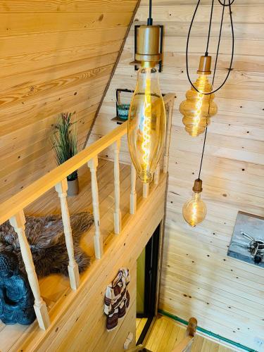 a staircase in a log cabin with lights at CABANA 365 in Braşov