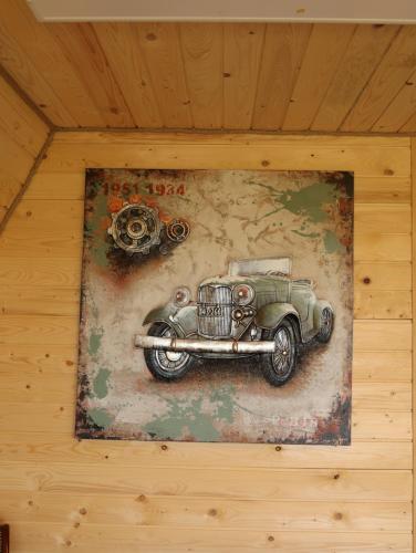 a painting of an old car on a wall at CABANA 365 in Braşov