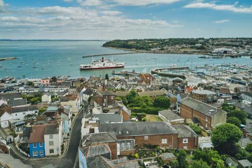 a city with a harbor and a boat in the water at Harold House in Cowes