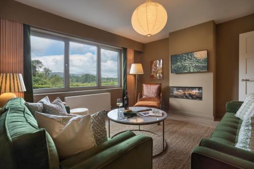 a living room with a couch and a table at Barakat Lakes Escape, Ambleside - Ridgestone in Ambleside