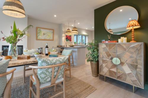 a kitchen and dining room with a table and a mirror at Barakat Lakes Escape, Ambleside - Ridgestone in Ambleside