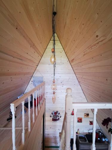a staircase in a cabin with wooden ceiling at CABANA 365 in Braşov
