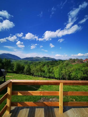 a wooden bench with a view of the mountains at CABANA 365 in Braşov