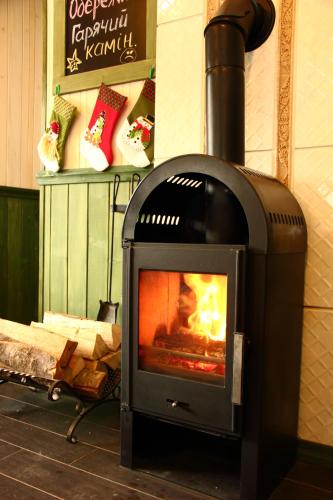 a stove with a fire in a room at Chalet CrepDeChine Hotel in Bukovel