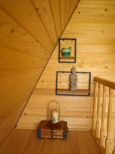 a room in a cabin with a staircase and a candle at CABANA 365 in Braşov