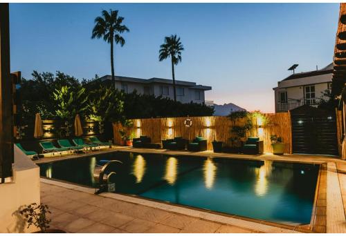 a swimming pool in a backyard with a fence at Sunside Inn Hotel in Kyrenia