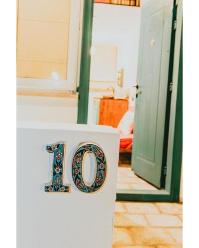 a sign with the number on a wall at Sunside Inn Hotel in Kérynia