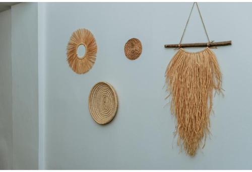 a group of straw hats hanging on a wall at Sunside Inn Hotel in Kérynia