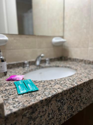 a bathroom counter with a sink and a toothpaste at Departamentos Hipolito Yrigoyen in San Rafael
