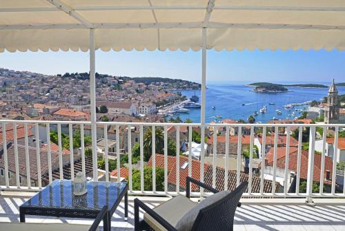 a balcony with chairs and a view of the water at Apartments and Rooms Bonkan Hvar in Hvar