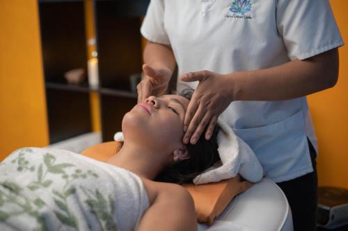 a woman getting her hair washed by a nurse at Indian Palace Hotel Boutique Spa & Restaurante in Antigua Guatemala