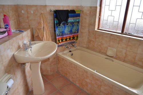 a bathroom with a sink and a bath tub and a sink at 2Bed 2Bath Vacation home with pool close to beach in Margate