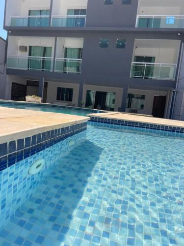 a swimming pool with a frisbee in front of a building at Pousada Arraial Beach in Arraial do Cabo