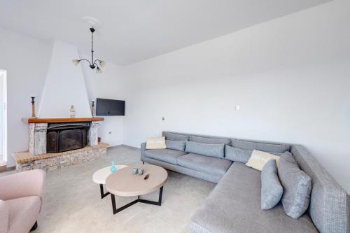 a living room with a couch and a fireplace at Captain View in Ano Syros