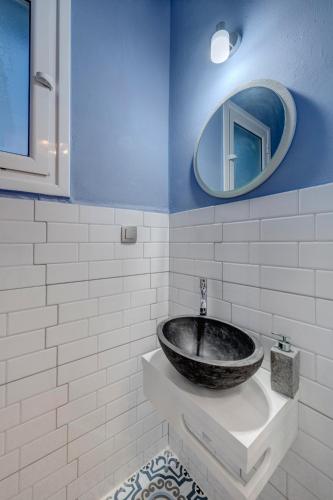 a bathroom with a stone sink and a mirror at Captain View in Ano Syros