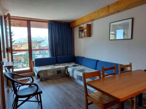 un salon avec un canapé, un lit et une table dans l'établissement Appartement 2 pièces 6 pers. avec balcon proche des pistes et commerces - Arc 1800, Les Villards - FR-1-411-207, à Arc 1800