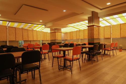 DāpuriHotel Bramha Inn Aundh Wakad Rooms Restaurant Banquet的一间有桌椅的餐厅
